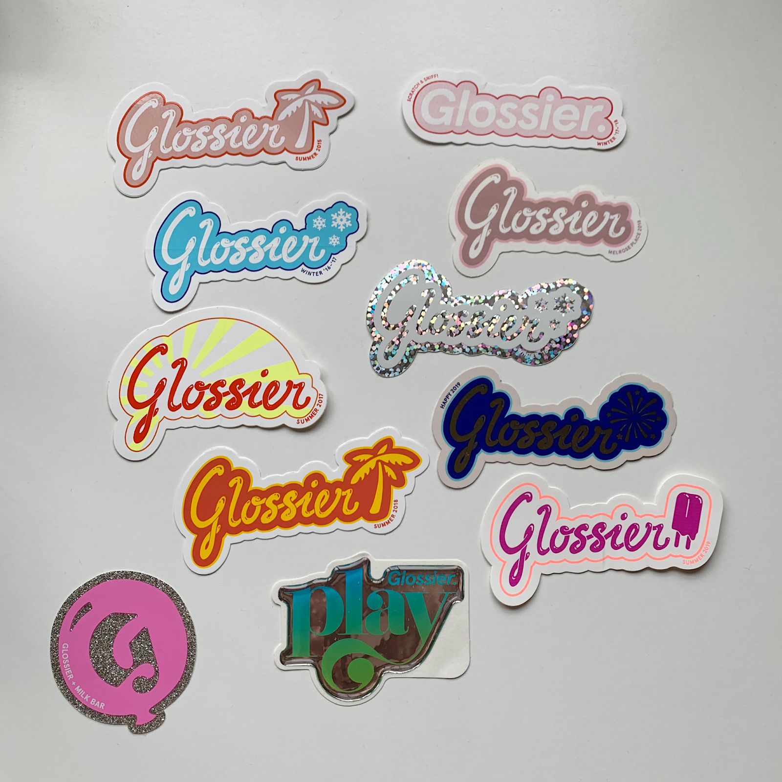 Some of the branded stickers that Glossier has included in their packages.