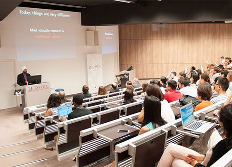 A professor standing in front of his class. 
