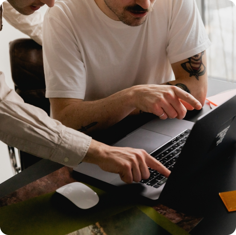 Two people working together at a laptop
